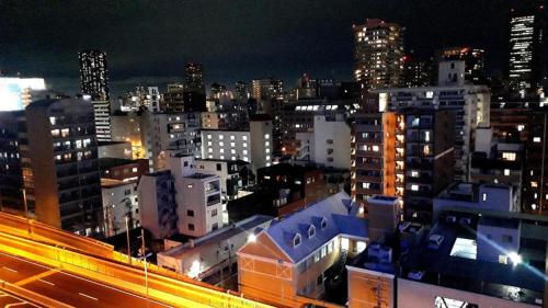 a view of a city at night with buildings at Toyoko Inn Osaka Umeda Higashi in Osaka