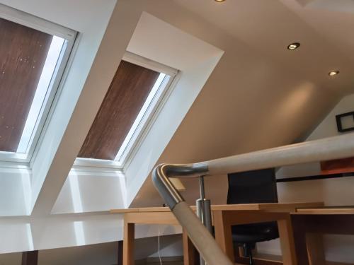 a staircase with two windows in a house at BALCON Apartments in Bled