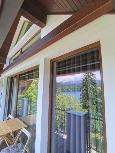 a screened in porch with a view of a lake at BALCON Apartments in Bled