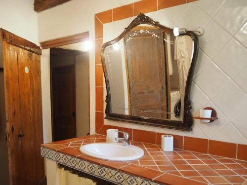 a bathroom with a sink and a mirror at Cozy Noves Home with Pool Access in Noves