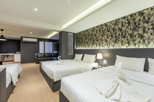 Postel nebo postele na pokoji v ubytování Siam Star Hotel