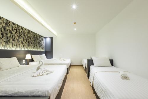 Postel nebo postele na pokoji v ubytování Siam Star Hotel