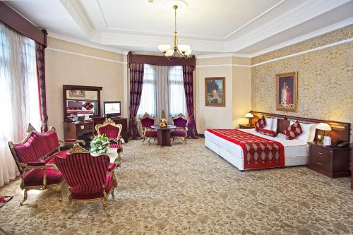 a hotel room with a bed and a table and chairs at Legacy Ottoman Hotel Istanbul Old City in Istanbul
