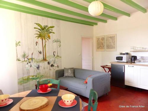 un salon avec un canapé et une table dans l'établissement Longère XVIIIe rénovée avec jardin, proche forêt et loisirs, animaux bienvenus - FR-1-489-376, à Lurcy-Lévis