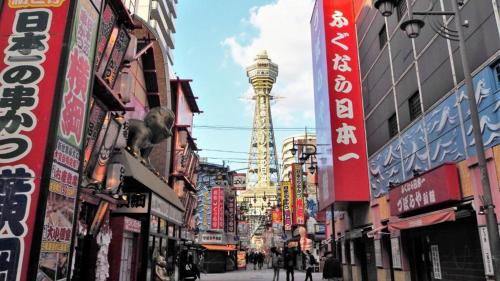 a busy city street with buildings and a tower at Toyoko Inn Osaka Semba Higashi in Osaka