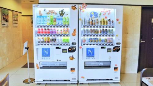 a white refrigerator filled with bottles of soda at Toyoko Inn Osaka Kadoma-shi Ekimae in Osaka