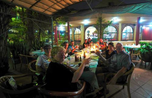 a group of people sitting at a table in a restaurant at Speke Hotel 1996 Ltd in Kampala