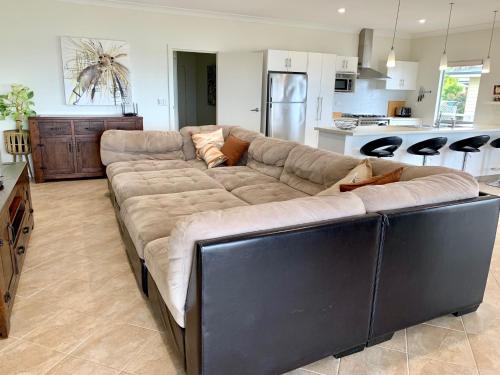 a living room with a large couch in a kitchen at Africaine Voyage in Kingscote