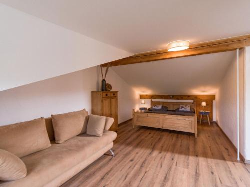 a living room with a couch and a desk at Ferienwohnungen beim Silbergersee in Oberaudorf