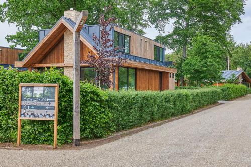 a building with a sign in front of it at Bergvliet Villa's in Oosterhout