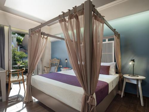 a bedroom with a four poster bed with a canopy at Elia Potie in Chania Town