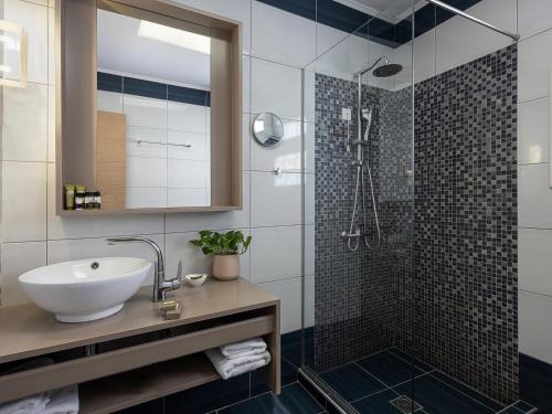 a bathroom with a sink and a shower at Elia Potie in Chania Town