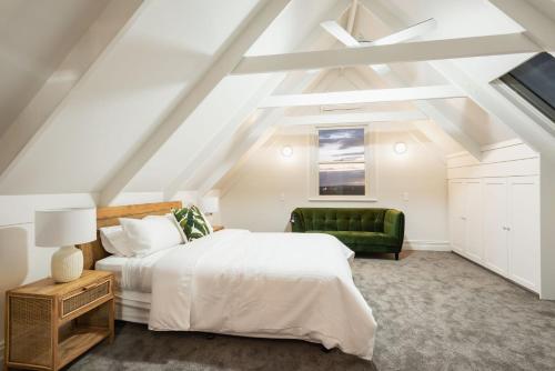a bedroom with a bed and a green couch at Yarrawong Farm, near Berry in Jaspers Brush