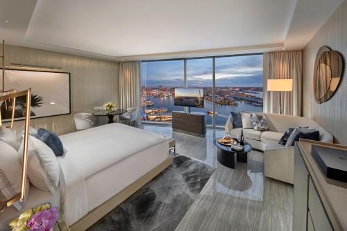 a bedroom with a large bed and a living room at Crown Towers Sydney in Sydney