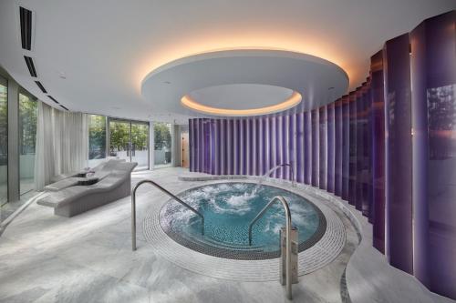 a large bathroom with a hot tub in the middle at Crown Towers Sydney in Sydney