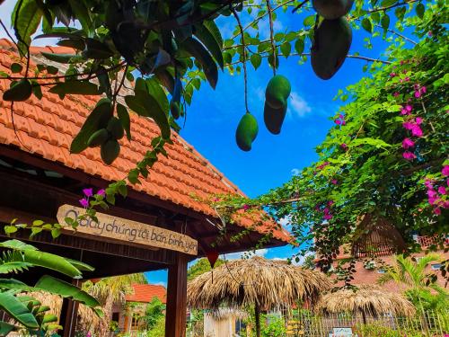 a sign in front of a building with flowers at Trang An Village Homestay in Ninh Binh