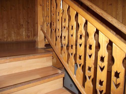 a wooden staircase with wooden treads on the wall at Hercules Turistaház in Szentendre