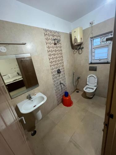 a bathroom with a sink and a toilet at Avuraa Hospitality India in Chennai