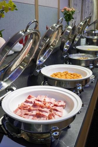 a buffet with plates of food on a table at Gyeongju GG Tourist Hotel in Gyeongju