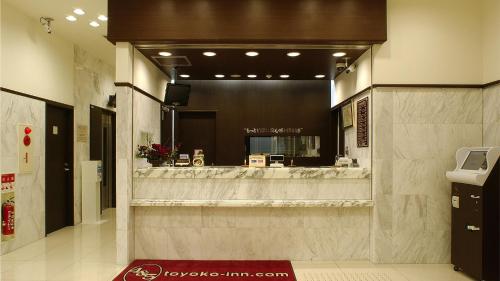 a lobby with a hair salon with a large mirror at Toyoko Inn Osaka Tsuruhashi Ekimae in Osaka