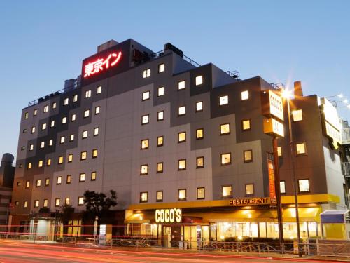 a building with a sign on top of it at Tokyo Inn in Tokyo