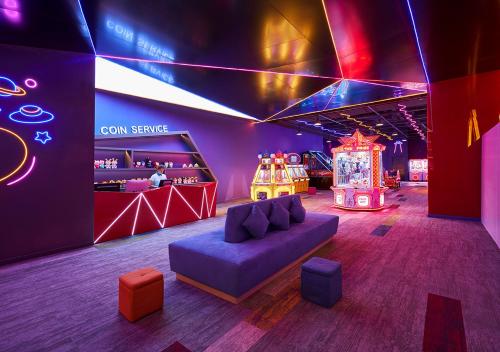 a room with a couch and a game room at Holiday Inn Resort Ho Tram Beach by IHG in Ho Tram