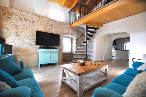 a living room with a blue couch and a table at Villa Gisella in Nedeščina