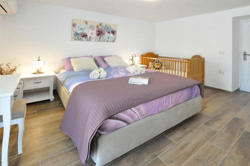 a bedroom with a bed and a desk at Villa Gisella in Nedeščina