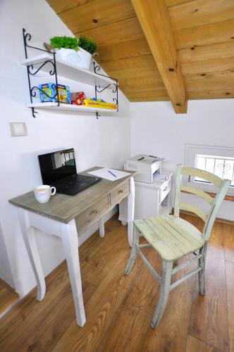 a desk with a laptop and a chair in a kitchen at Villa Gisella in Nedeščina