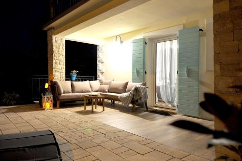 a living room with a couch on a patio at Villa Gisella in Nedeščina