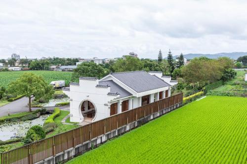 a house with a fence and a green yard at Hualien Toongmao Resort in Jian