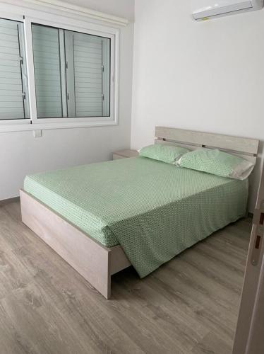 a bedroom with a bed in a white room at The Anemoni 5 Villa in Protaras