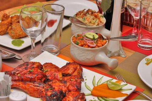 a table with plates of food on a table at Harmony Hotel in Addis Ababa