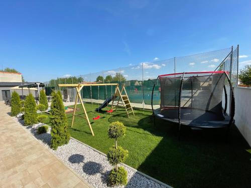 a backyard with a playground with a trampoline at Penzion Kurtovka Staňkovice in Staňkovice