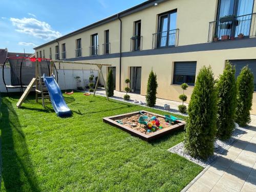 a backyard with a slide and a playground at Penzion Kurtovka Staňkovice in Staňkovice