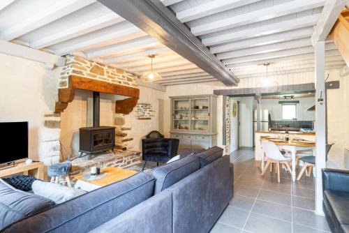 un salon avec un canapé bleu et une cheminée dans l'établissement Bel Even, à Plouër-sur-Rance
