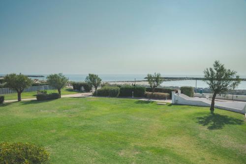a view of a park with the ocean in the background at Thalacap Camargue in Saintes-Maries-de-la-Mer