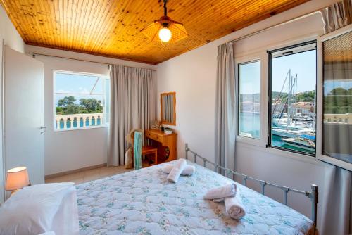 a bedroom with a bed with a view of a harbor at "OceanBreeze'' Studio in Gaios