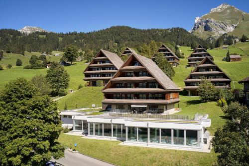 an aerial view of a building with a mountain at Reka-Feriendorf Wildhaus in Wildhaus