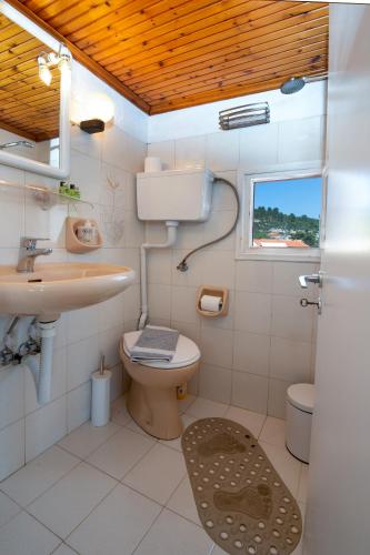 a bathroom with a toilet and a sink at "OceanBreeze'' Studio in Gaios