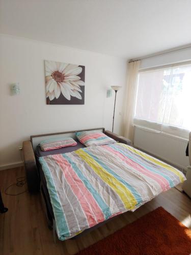 a bedroom with a bed with a flower picture on the wall at Entspann you in Wangerland