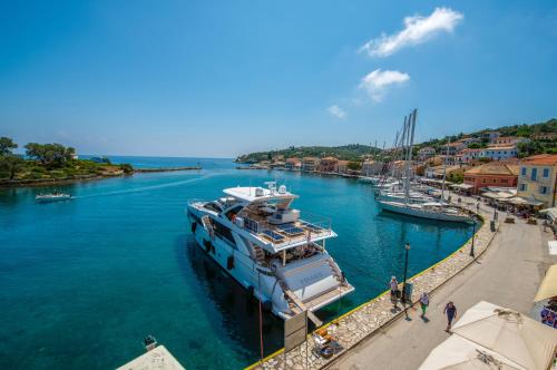 a boat docked at a dock in a river at "OceanBreeze'' Studio in Gaios