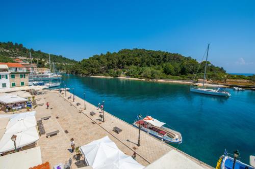 a boat is docked at a dock in the water at "OceanBreeze'' Studio in Gaios
