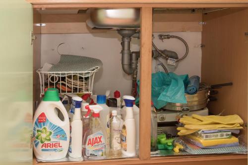 a cabinet filled with lots of bottles of cleaner at STAVROS Studio Apartment in kos town in Kos Town