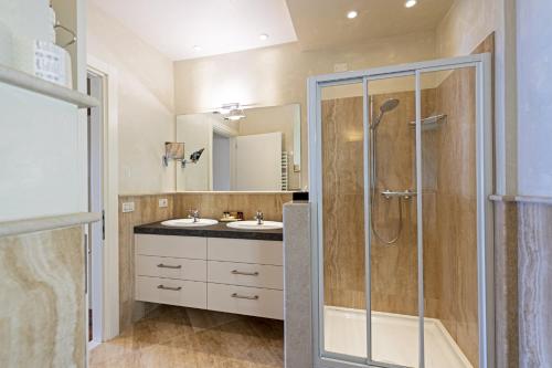 a bathroom with a shower and a sink at Hotel Baia D'Oro - Adults Only in Gargnano