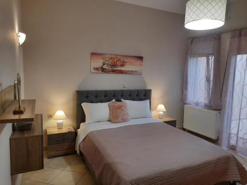 A bed or beds in a room at Pavlos Apartment
