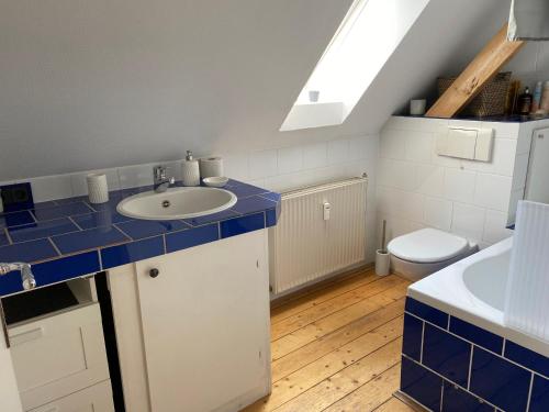 a bathroom with a sink and a toilet at Messeapartment Stockum in Düsseldorf