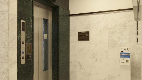 a door in a building with a sign on it at Toyoko Inn Tokyo Tameike-sanno-eki Kantei Minami in Tokyo