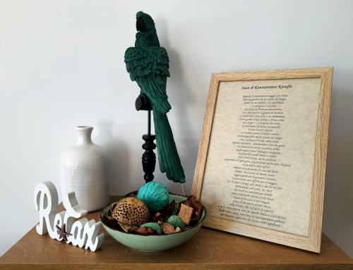 a bowl on a table with a picture and a book at Itaca in Lido di Fermo