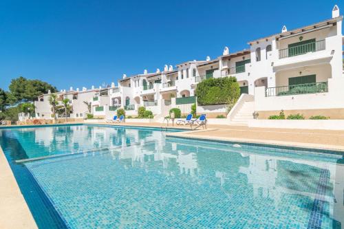 a swimming pool in front of a building at Ses Fonts C25 in Son Parc